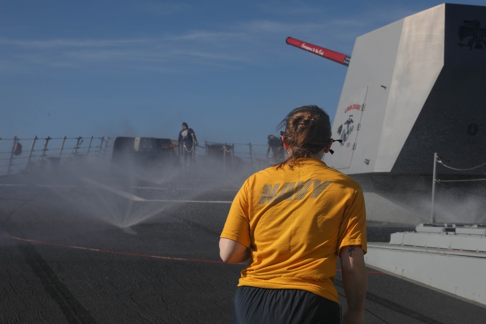 Sailors aboard the USS Rafael Peralta (DDG 115) conduct a countermeasure wash down in the East China Sea