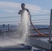 Sailors aboard the USS Rafael Peralta (DDG 115) conduct a freshwater wash down in the East China Sea