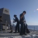 Sailors aboard the USS Rafael Peralta (DDG 115) conduct a freshwater wash down in the East China Sea