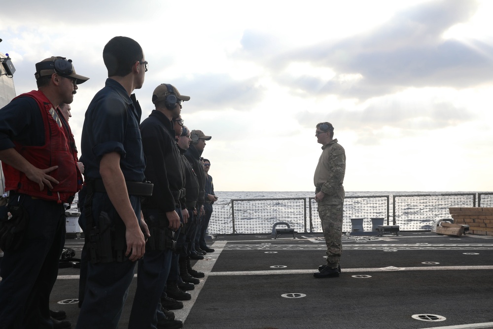 Sailors aboard the USS Rafael Peralta (DDG 115) conduct a small arms shoot in the East China Sea
