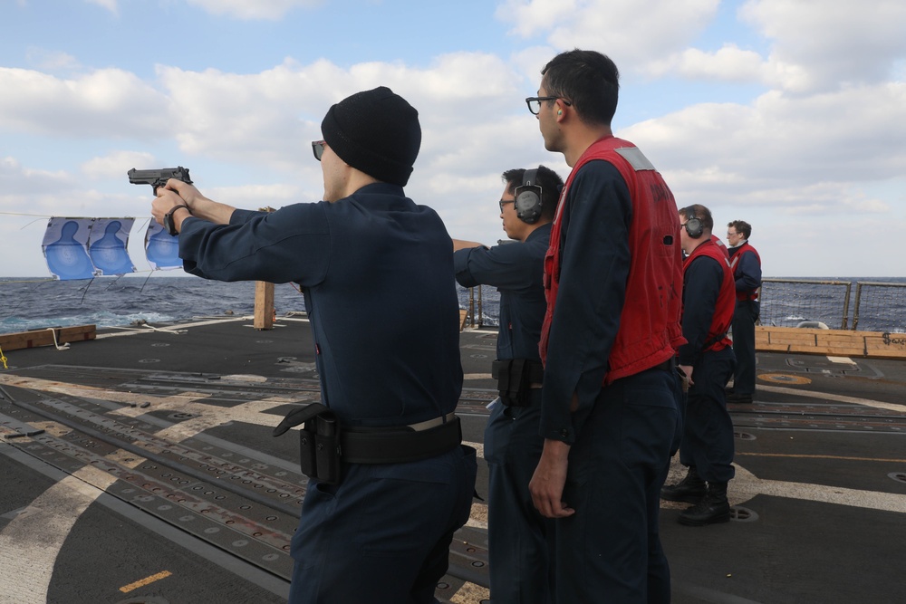 Sailors aboard the USS Rafael Peralta (DDG 115) conduct a small arms shoot in the East China Sea
