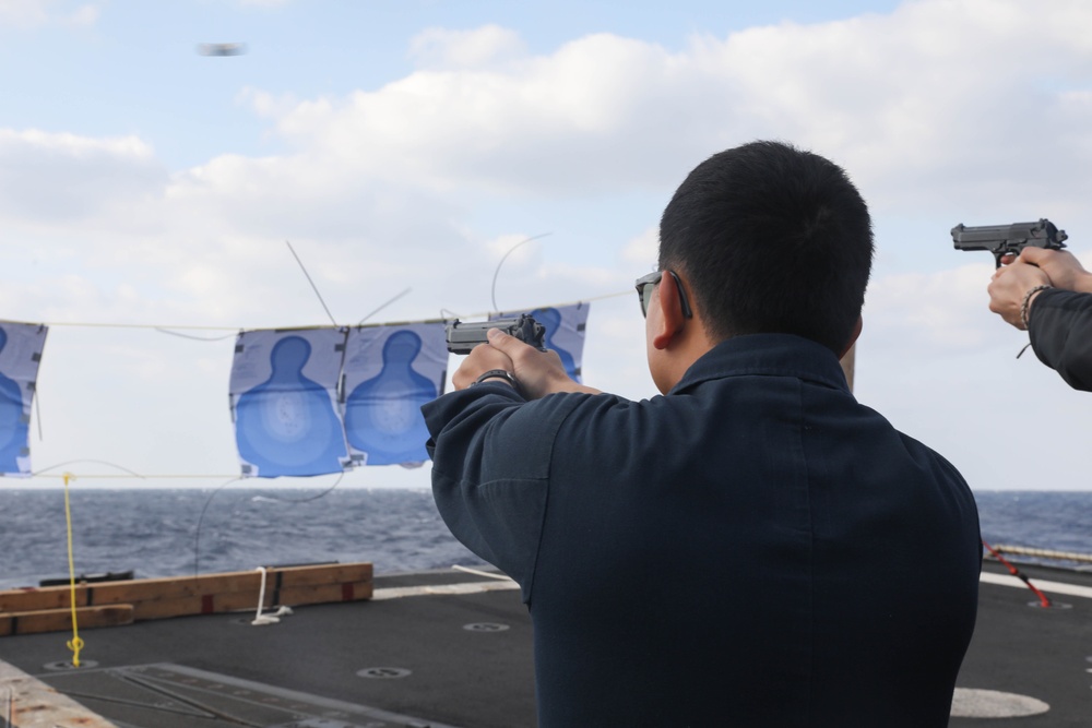 Sailors aboard the USS Rafael Peralta (DDG 115) conduct a small arms shoot in the East China Sea