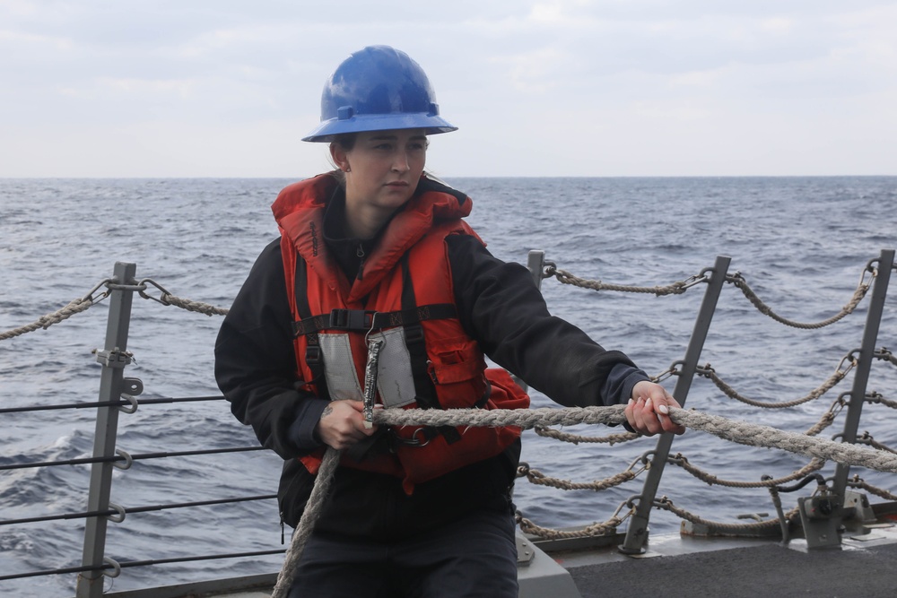 Sailors aboard the USS Rafael Peralta (DDG 115) conduct a replenishment-at-sea with the USNS Big Horn in the East China Sea