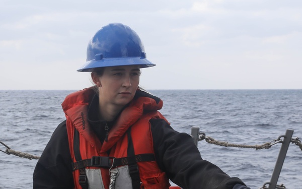 Sailors aboard the USS Rafael Peralta (DDG 115) conduct a replenishment-at-sea with the USNS Big Horn in the East China Sea