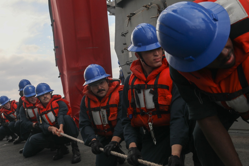 Sailors aboard the USS Rafael Peralta (DDG 115) conduct a replenishment-at-sea with the USNS Big Horn in the East China Sea