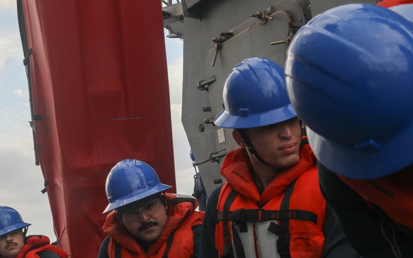 Sailors aboard the USS Rafael Peralta (DDG 115) conduct a replenishment-at-sea with the USNS Big Horn in the East China Sea