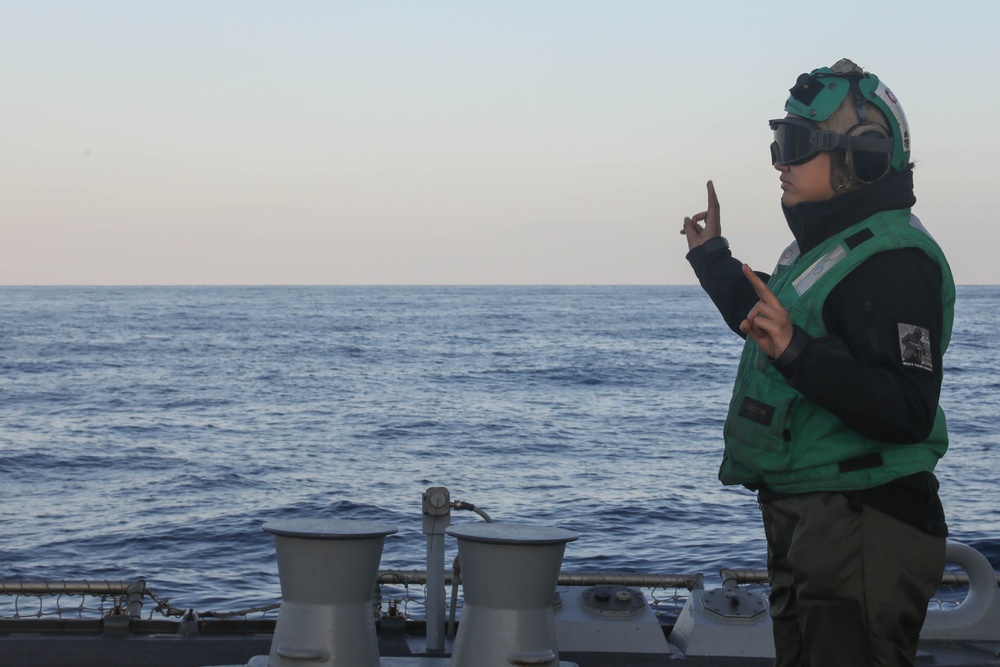 Sailors aboard the USS Rafael Peralta (DDG 115) conduct flight quarters in the East China Sea