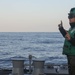 Sailors aboard the USS Rafael Peralta (DDG 115) conduct flight quarters in the East China Sea