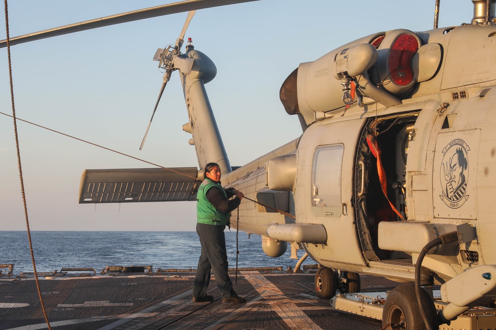 Sailors aboard the USS Rafael Peralta (DDG 115) conduct flight quarters in the East China Sea