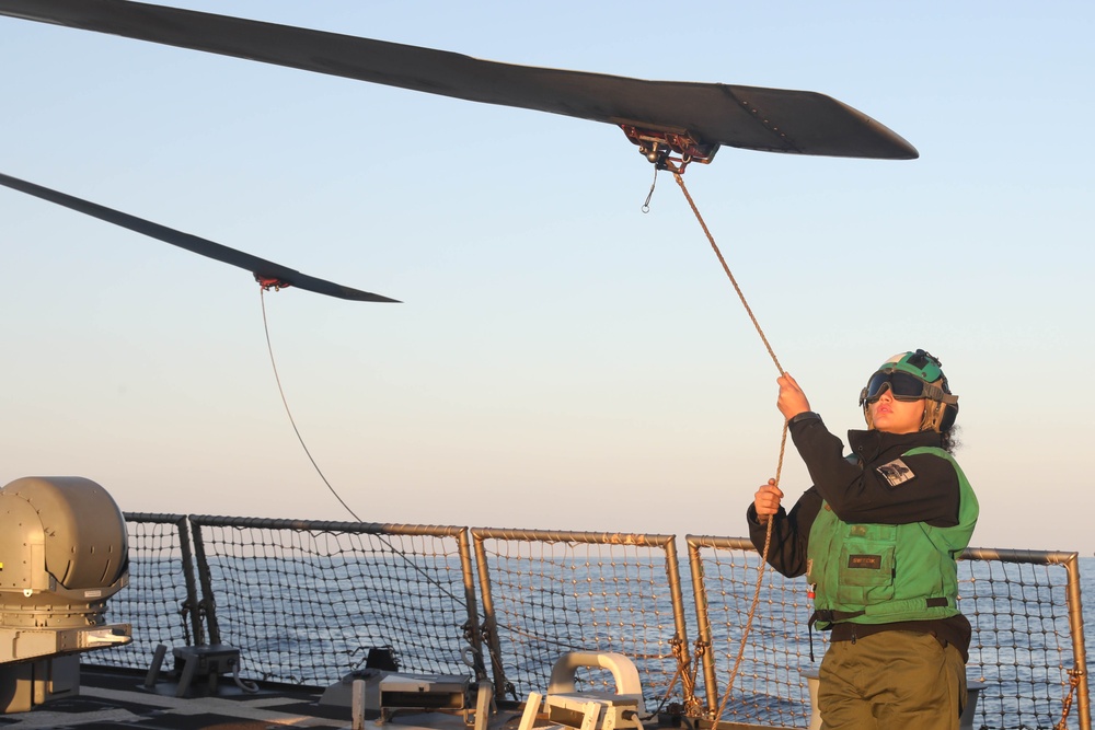 Sailors aboard the USS Rafael Peralta (DDG 115) conduct flight quarters in the East China Sea