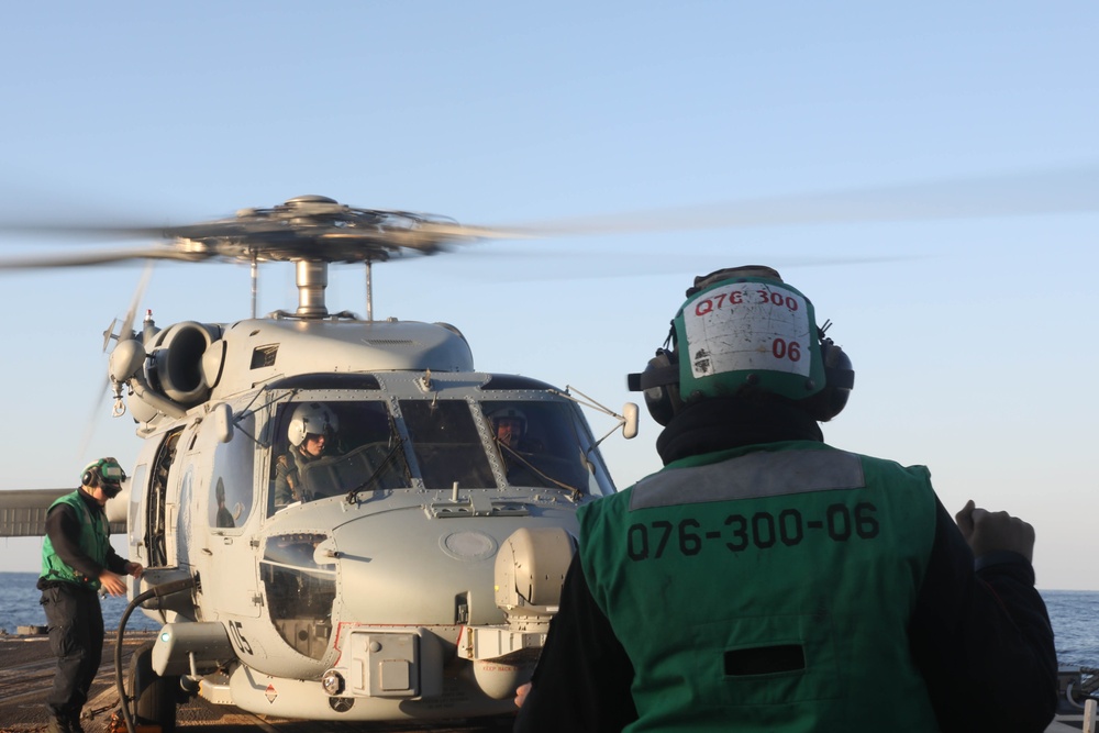 Sailors aboard the USS Rafael Peralta (DDG 115) conduct flight quarters in the East China Sea