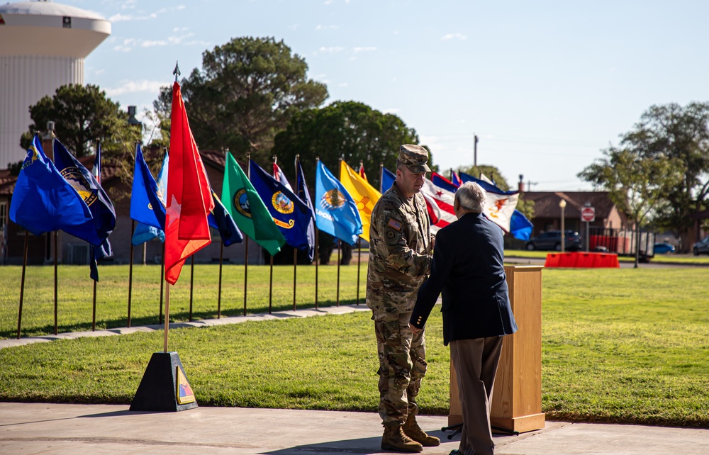 Maj. Gen. James P. Isenhower III shakes hands with former POW