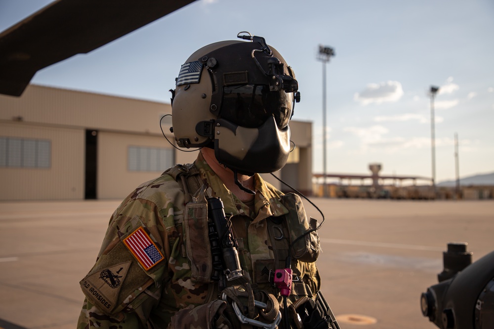 U.S. Army Crew Chief conducts pre-flight checks