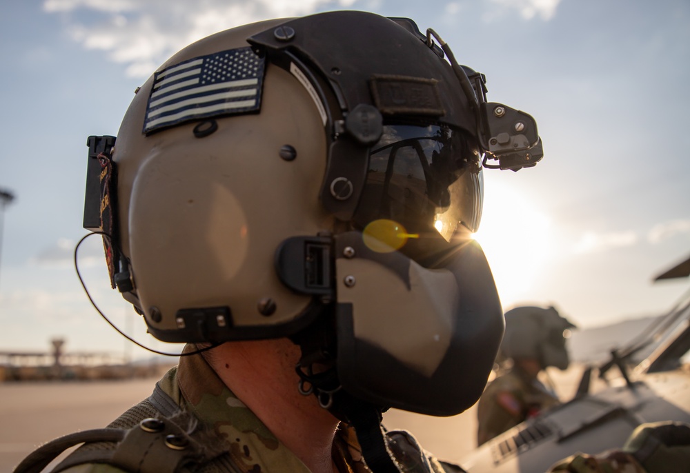 U.S. Army Crew Chief conducts pre-flight checks