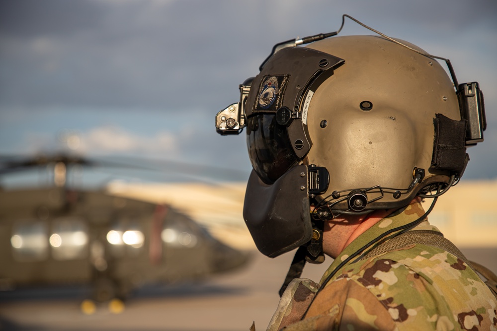 U.S. Army Crew Chief conducts pre-flight checks