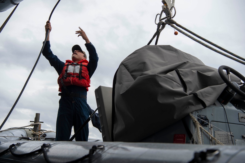 USS Kidd (DDG 100) Sailor Performs Small Boat Maintenance