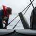 USS Kidd (DDG 100) Sailor Performs Small Boat Maintenance