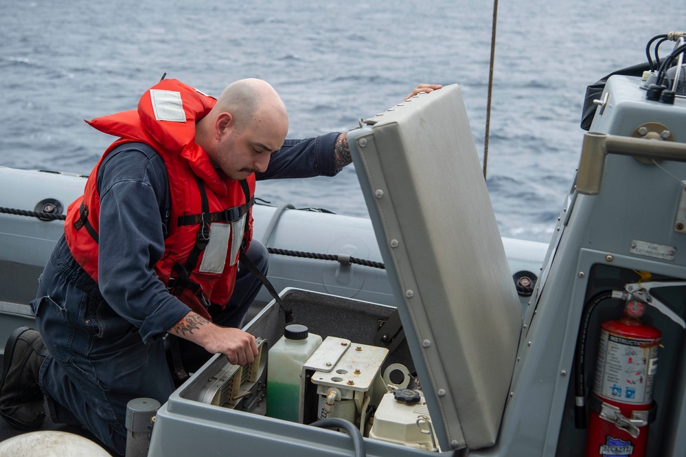 USS Kidd (DDG 100) Sailor Performs Small Boat Maintenance