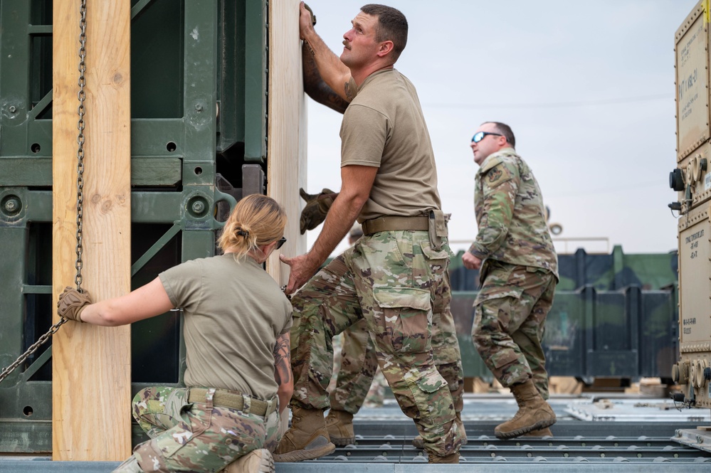 Soldiers and Airmen prepare Patriot Missiles for transportation