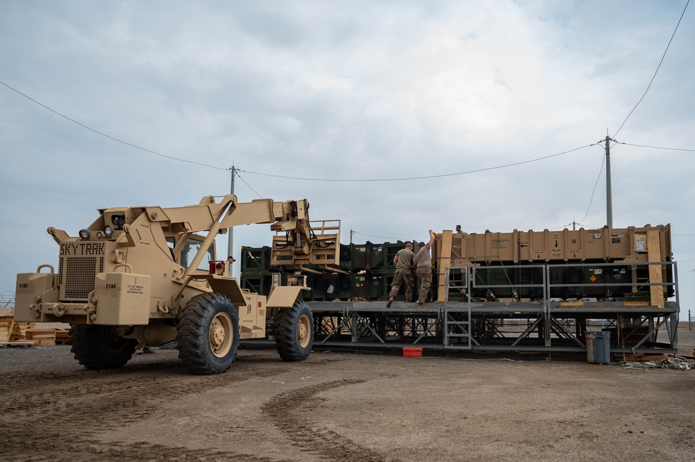 Soldiers and Airmen prepare Patriot Missiles for transportation