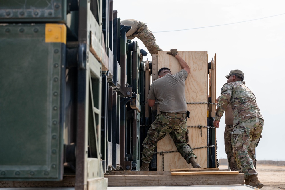 Soldiers and Airmen prepare Patriot Missiles for transportation