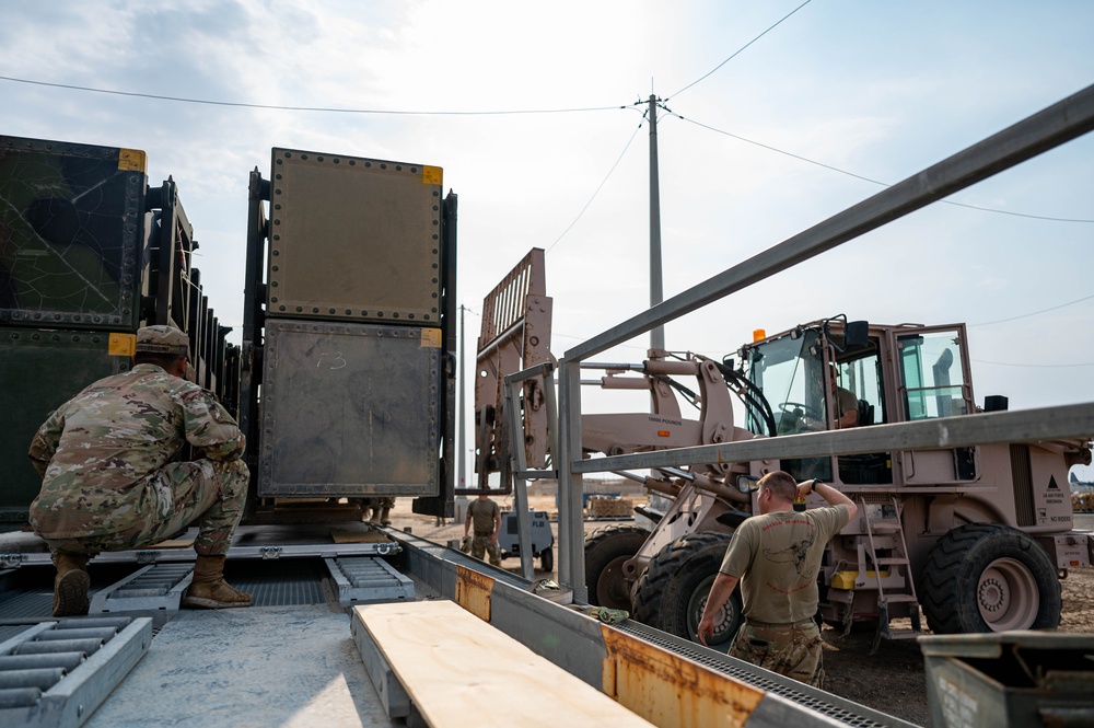 Soldiers and Airmen prepare Patriot Missiles for transportation