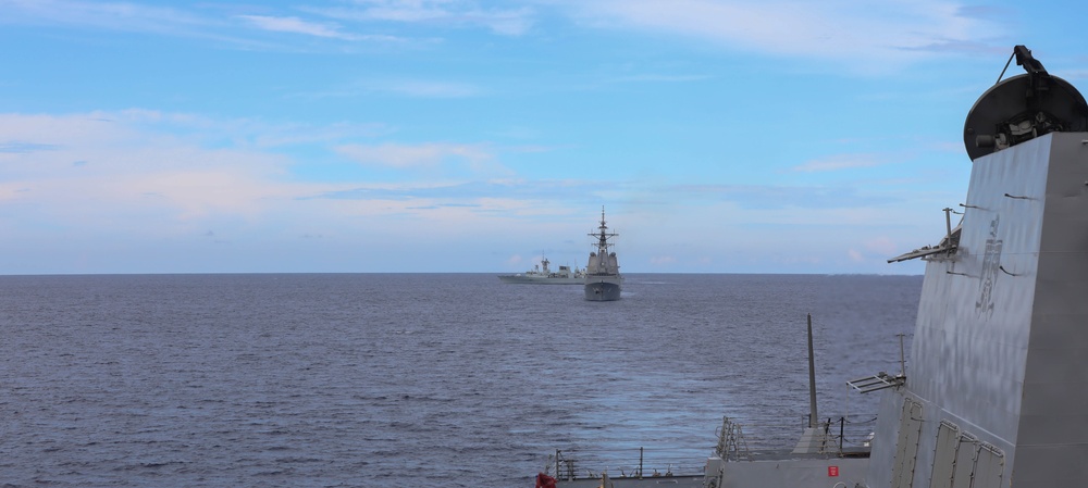 Sailors aboard the USS Rafael Peralta (DDG 115) conduct a live fire exercise with the HMCS Ottawa (FFH 341) and the HMAS Brisbane (DDG 41) as part of operation Noble Wolverine in the South China Sea