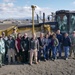 NAS Fallon Commanding Officer stands with members of Puyenpa Construction, Duckwater Shoshone Tribe, NAVFAC PWD Fallon, and NAVSUP Fallon at the construction site.
