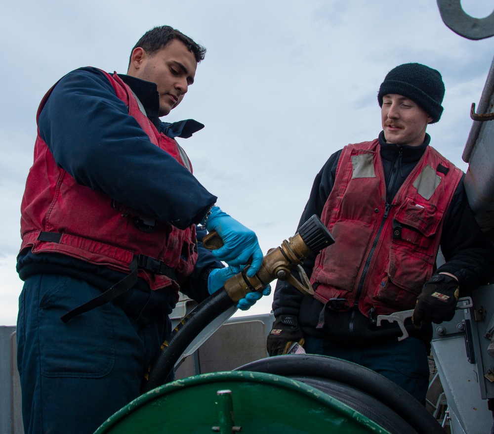 U.S. Navy Sailors Maintain Fire Hose