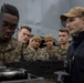 Marines familiarize themselves with machine guns aboard the USS New York