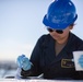 USS Tripoli Sailor Paints Flight Deck Combing