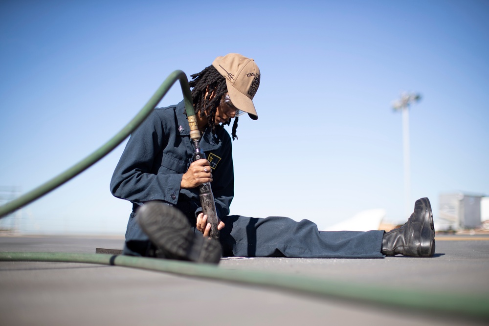 USS Tripoli Sailor Performs Maintenance on the Flight Deck