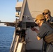 Marines and Sailors aboard the USS New York fire machine guns
