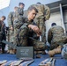 Marines and Sailors aboard the USS New York fire machine guns