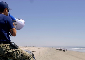 SWCC Instructor Motivates SWCC Candidates During a Beach Run