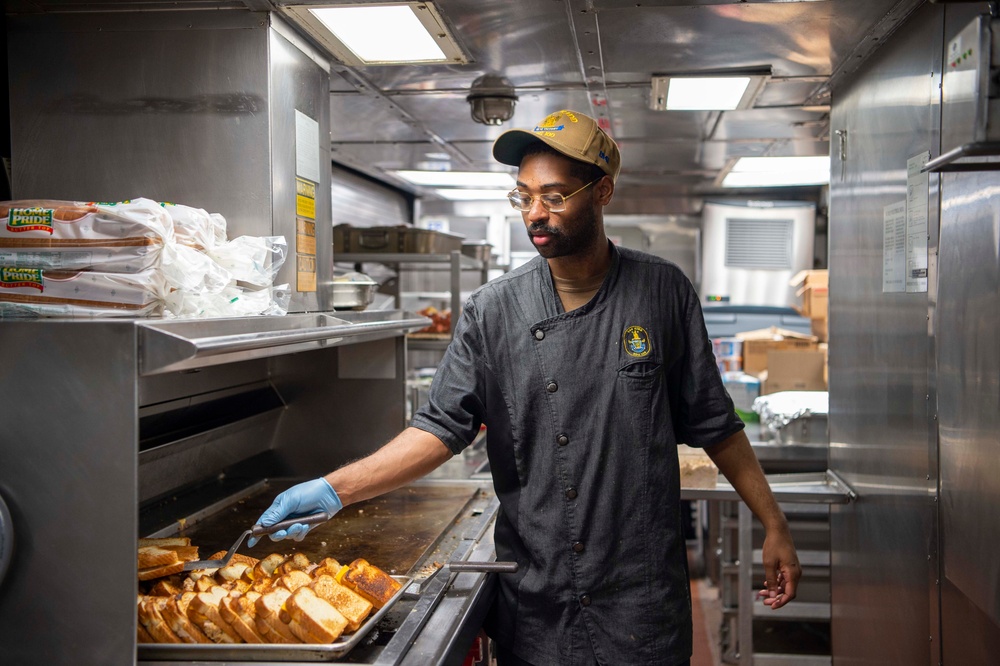 USS Kidd (DDG 100) Sailor Prepares Lunch