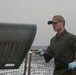 Sailors aboard the USS Rafael Peralta (DDG 115) clean a Seahawk helicopter (MH-60R) in the Sea of Japan