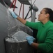 Sailors aboard the USS Rafael Peralta (DDG 115) clean a Seahawk helicopter (MH-60R) in the Sea of Japan