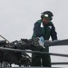 Sailors aboard the USS Rafael Peralta (DDG 115) clean a Seahawk helicopter (MH-60R) in the Sea of Japan