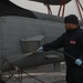 Sailors aboard the USS Rafael Peralta (DDG 115) clean a Seahawk helicopter (MH-60R) in the Sea of Japan