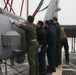 Sailors aboard the USS Rafael Peralta (DDG 115) clean a Seahawk helicopter (MH-60R) in the Sea of Japan