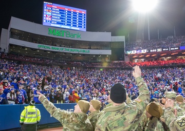 Soldiers Wave at a Crowd During an NFL Game