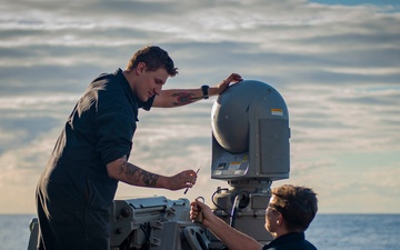 USS Hopper (DDG 70) Sailors Perform Maintenance on a shipboard weapons system in the Pacific Ocean