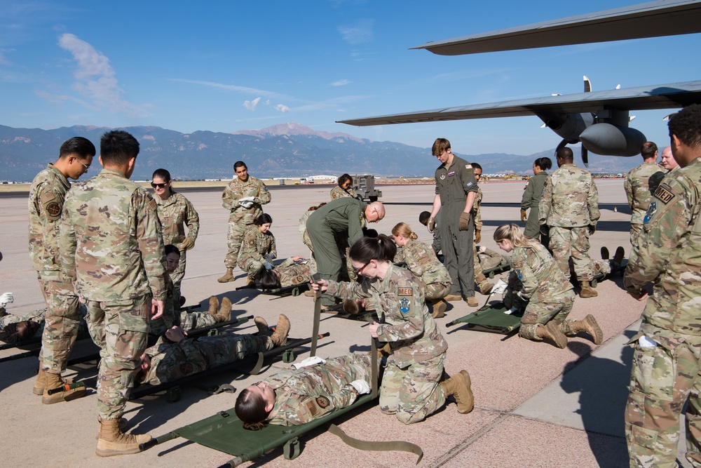Reservist flight paramedics train active duty ground medical team on C-130H patient transfer