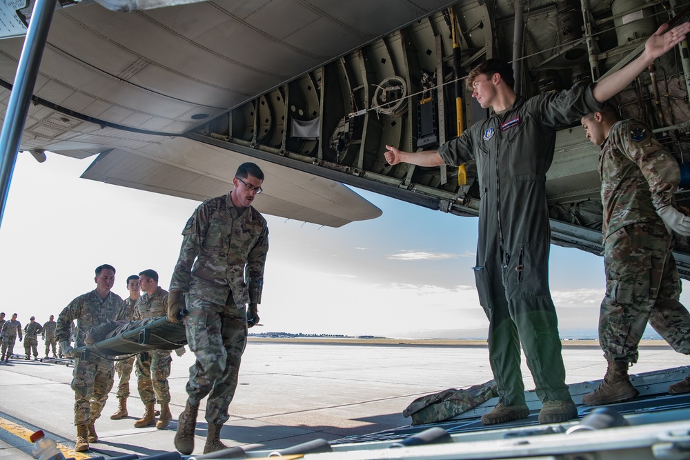 Reservist flight paramedics train active duty ground medical team on C-130H patient transfer