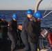 Sailors aboard the USS Rafael Peralta (DDG 115) conduct a sea and anchor detail in Yokosuka, Japan