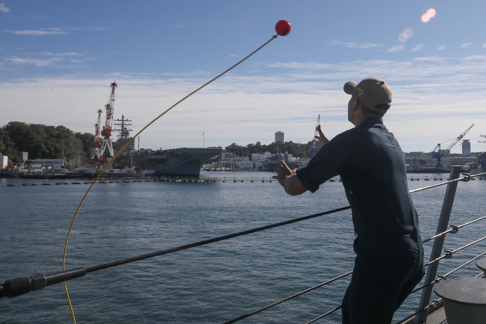 Sailors aboard the USS Rafael Peralta (DDG 115) conduct a sea and anchor detail in Yokosuka, Japan