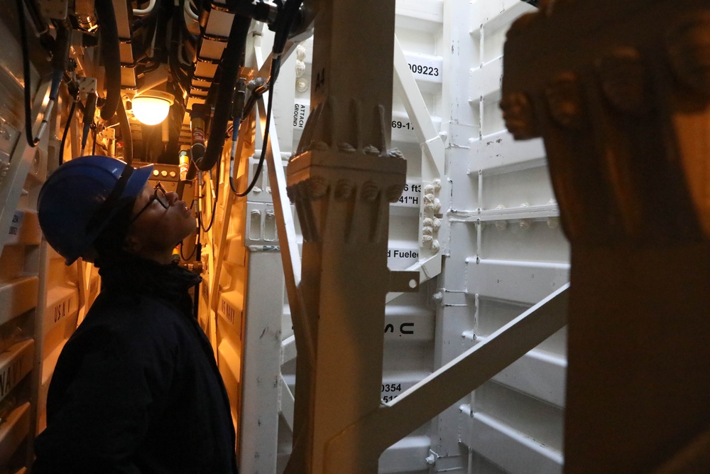 Sailors aboard the USS Rafael Peralta (DDG 115) conduct a missile onload in Yokosuka, Japan