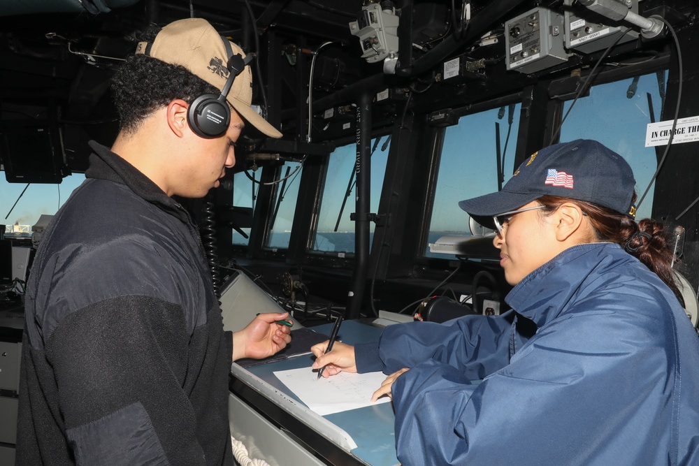 Sailors aboard the USS Rafael Peralta (DDG 115) conduct a sea and anchor detail in Yokosuka, Japan