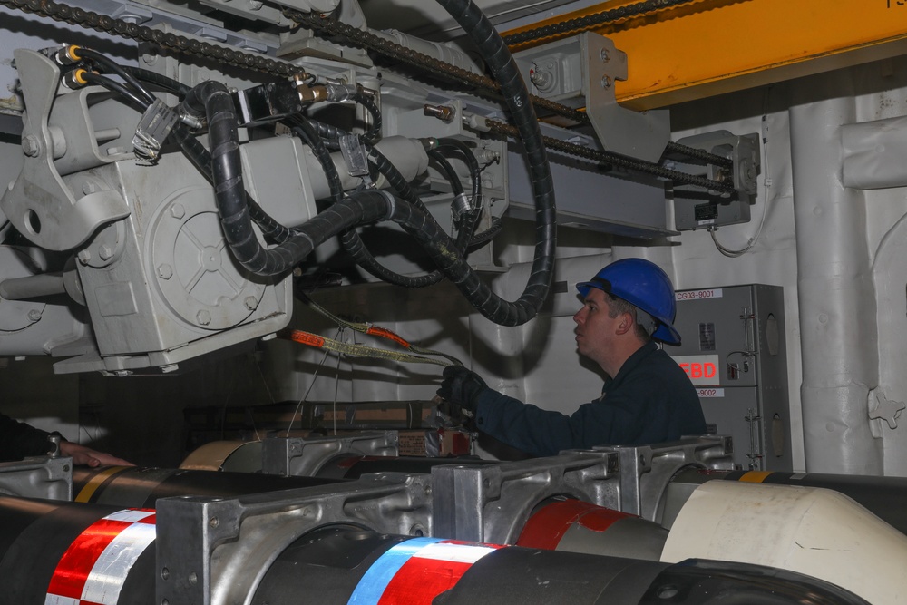 Sailors aboard the USS Rafael Peralta (DDG 115) conduct a torpedo handling event